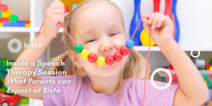 Child with autism in speech therapy session smiling